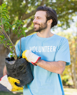 a-volunteer-man-holding-plant-DSXU42K.jpg